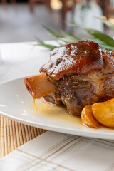 Pork shank braising with gravy and roasted potatoes