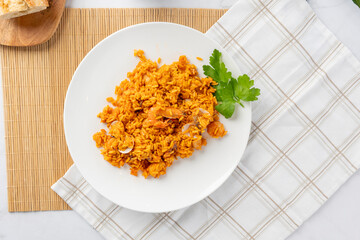 Serving traditional spanish seafood paella with shrimp and rice