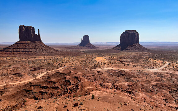 Aerial view of the sun-baked, monumental rock formations stand sentinel over the parched, cracked earth, a testament to the arid beauty of the desert landscape, Sedona, Arizona, United States.