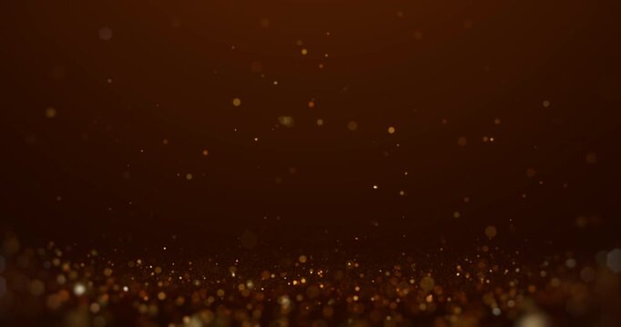 Golden glitter particles floating in the air over a dark brown background, creating a warm festive and elegant atmosphere perfect for luxury or celebration designs.