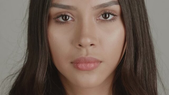 High-quality 4K studio shots of two diverse young women. Focused on face and eyes against a simple grey background. Excellent for beauty, cosmetic, identity, and health advertising.