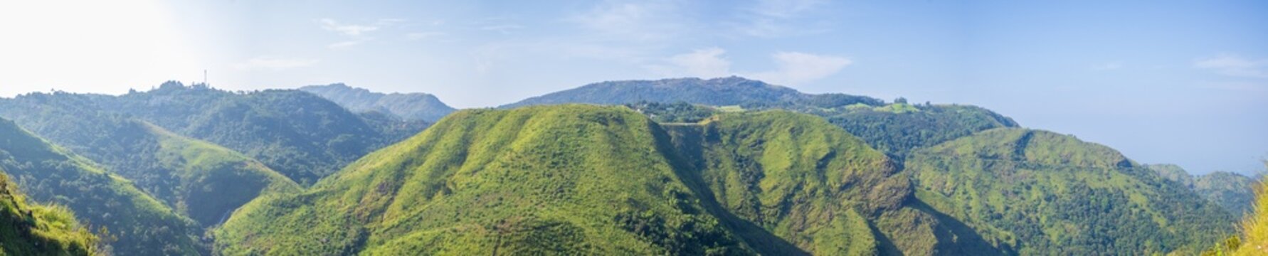 Expansive panorama of Vagamon hill station, Kerala, featuring verdant valleys and dramatic mountain ranges in daylight, perfect for beauty and adventure concepts