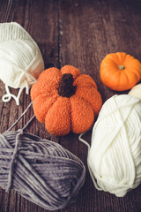 New skeins of chunky and soft yarn, vintage room and autumn decorations in the background
