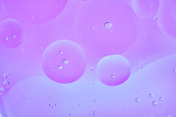 Abstract macro shot of light violet translucent bubbles floating in liquid, creating a modern pastel background. Horizontal format, soft gradients, dreamy, with space for design or text