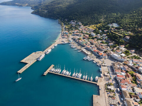 Aerial view of the vibrant port of Sami, where turquoise waters meet the quaint town nestled against the verdant hills, Sami, Cephalonia, Greece.