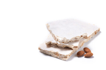 Delicious almond nougat isolated on white background. Traditional Christmas sweet. Copy space