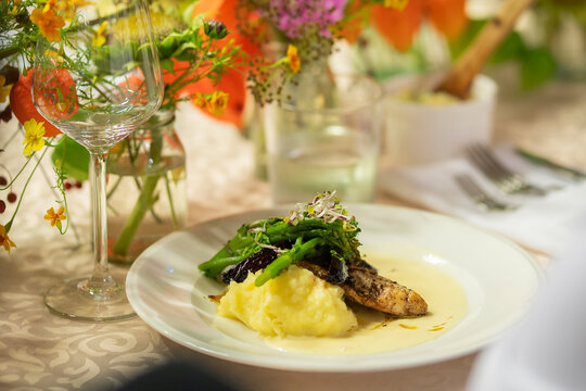 Crispy white fish fry on the festive table. Fried zander fillet in breading with mashed potatoe and vegetables. 