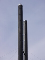 Low angle view of two old industrial chimneys