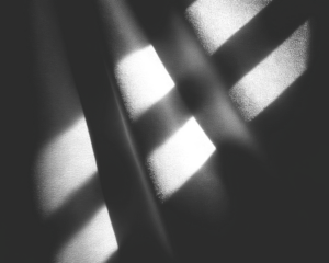 Geometric, abstract grayscale composition of intersecting shadows and rectangular voids