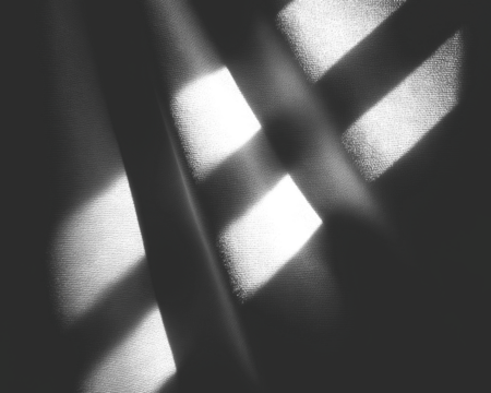 Geometric, abstract grayscale composition of intersecting shadows and rectangular voids