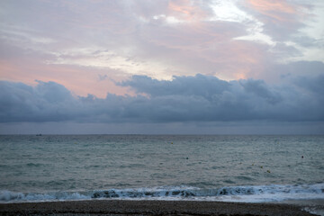 Sunrise over the sea with gentle waves washing the sandy beach, reflecting the golden sunlight....