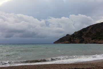 Sunrise over the sea with gentle waves washing the sandy beach, reflecting the golden sunlight. Peaceful and harmonious natural landscape.