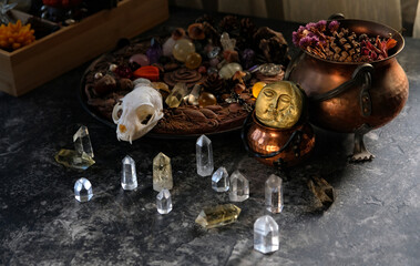 witch altar. amulets, talismans, animal skull, copper cauldrons, crystals, witchery stuff on table. Magic, witchcraft. esoteric spiritual ritual for relax, meditation. witchy workplace. litho therapy