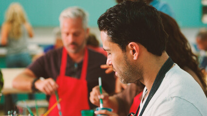 Group Of Mature Adults Attending Art Class In Community Centre