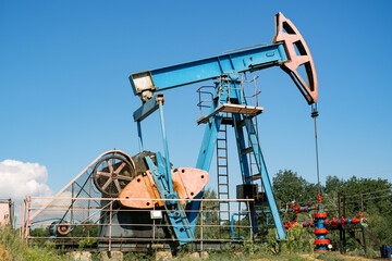Oil pump rig. An oil pump jack works in an open field extracting crude oil, Brent Oil Index futures price