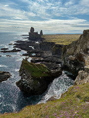 Rocky cliff coastline of Iceland in summer.