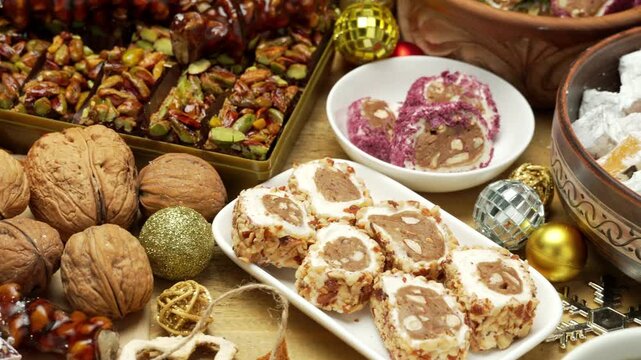 Beautiful and festive background for New Year holidays with candies and sweets and decorations, Sweet food Turkish delight on wooden background, assorted locum and candy for decorated backdrop

