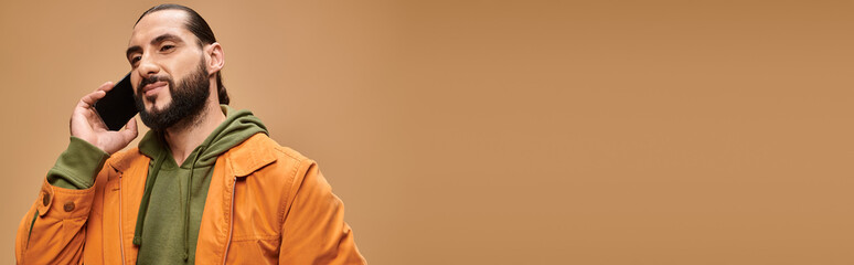 Handsome Middle Eastern man in casual fashion enjoys a moment in studio setting