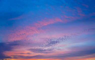 Beautiful sunset or sunrise sky with vibrant clouds changing from purple to orange is perfect for an abstract or nature background.