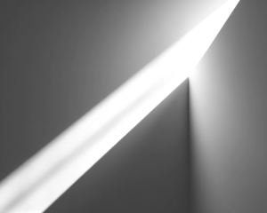 Angular black and grey shapes, sharp edges, and shadowed planes create abstract composition