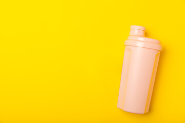 Protein shake with protein powder on a colored background. The powder is mixed with water or milk. A dietary supplement for a balanced diet. Whey protein. Fitness and gym diet nutrition.