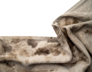 A wrinkled, dirty towel showcasing various stains and textures against a black background, highlighting its wear and age.