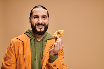 Handsome middle eastern man enjoys a sweet treat in stylish casual attire