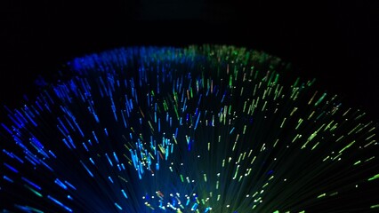 Spectrum Flow: The Dance of Fiber Lights. Vivid fiber optic lights in red, blue, green, and yellow. Symbolizing data flow, energy, and digital connection.