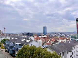 Panoramic city view of Brussels under cloudy autumn sky. Beautiful skyline with red rooftops....