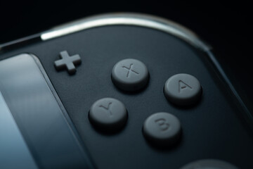 Detailed close-up of gaming joystick buttons and symbols. © CurvyLens