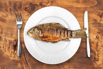Tasty fresh fish dish on desk background