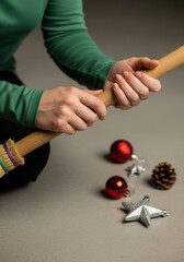 A person cleans up after the holidays with a broom. Sweeping up Christmas ornaments from the floor. The morning after a New Year celebration concept