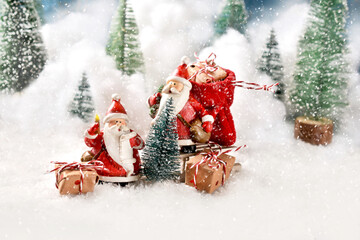 Two Santa Clauses with Christmas  presents having a break on the snowy road