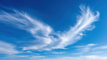Cirrus cloud formation against a vivid blue sky, creating a striking and ethereal atmospheric scene