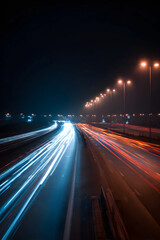 Obraz premium Streaking headlights and taillights blur on a dark highway at night