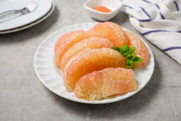 Peeled Pomelo it is a beneficial fruit and high in vitamin c , in white plate