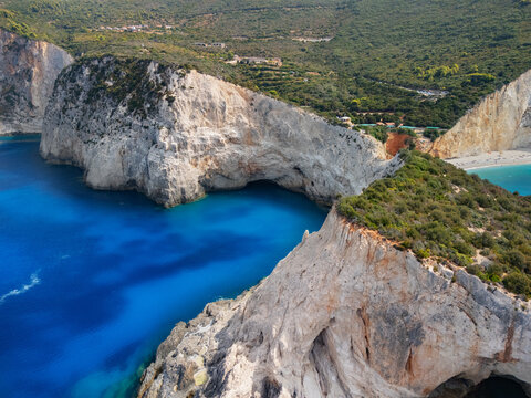 Aerial view of dramatic cliffs meeting the turquoise sea at Porto Katsiki beach, the landscape a symphony of rock and water, Lefkada, Lefkada, Greece.