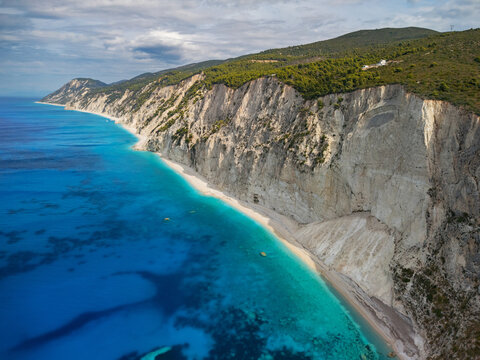 Aerial view of Porto Katsiki beach where turquoise waters meet the pale cliffs under a vast sky, Lefkada, Lefkada, Greece.