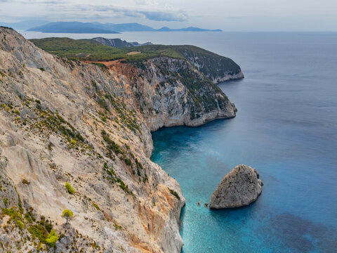 Aerial view of the rugged cliffs meeting the turquoise Ionian Sea at Porto Katsiki, a beach paradise, Lefkada, Lefkada, Greece.