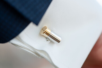 Elegant Gold and Silver Cufflink on a Formal White Shirt Sleeve
