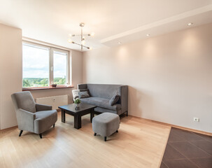 Stylish Modern Living Room with Natural Lighting and Cozy Furniture Arrangement