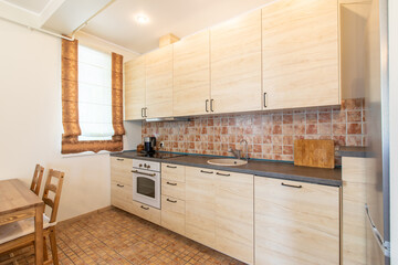 Modern Home Kitchen Interior with Wooden Cabinets and Comfortable Dining Space