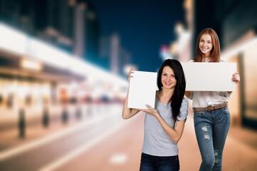 Happy young student woman holding signboard
