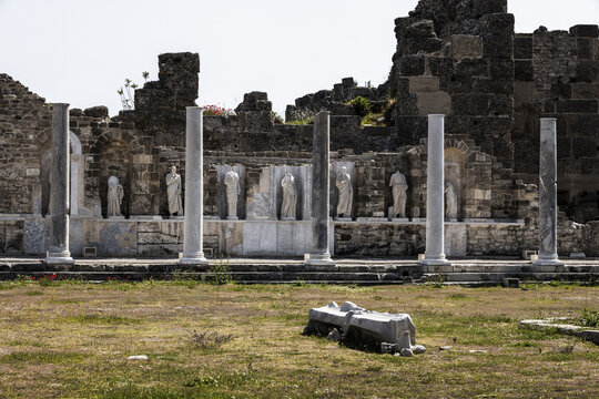 View of ancient marble columns standing guard over weathered statues in the old ruins, whispering tales of time in Side, Antalya, Turkey.