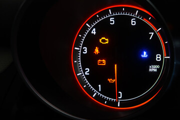 Many different car dashboard lights with warning lamps illuminated.