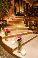 Elegant Floral Wedding Decor with Candlelit Staircase and Romantic Ambiance