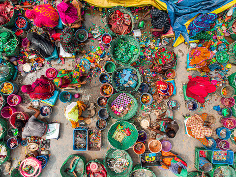 Joypurhat, Bangladesh - 25 September 2022: Aerial view of a vibrant mosaic of colorful garments and recycled plastic, creating a scene of organized chaos and industrious activity.