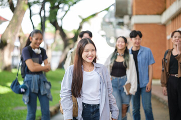 Happy university students walking together on campus, enjoying friendship and good vibes.