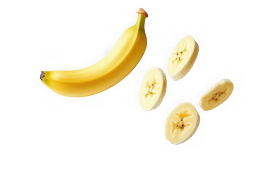Whole yellow banana and sliced banana pieces floating against a black background fruit