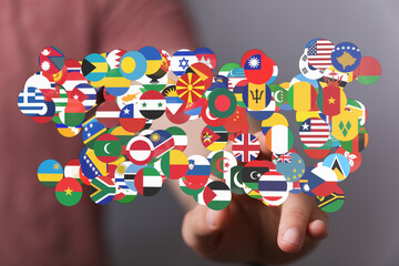 Conceptual image of a hand interacting with a collection of international flags, representing global unity, international relations, and the con